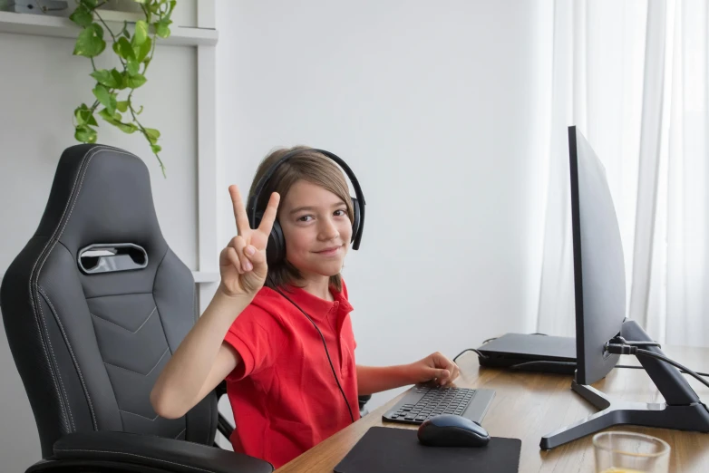 a little boy that is sitting in front of a computer