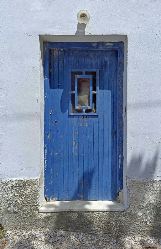 an blue door is opening to show a window