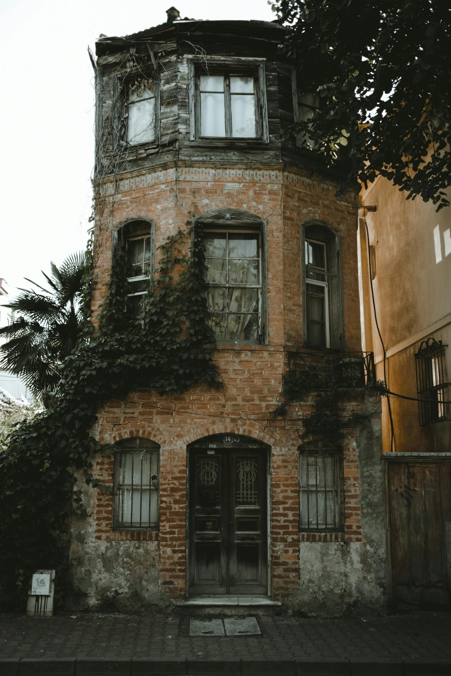 the house is made of brick with ivy growing up the front