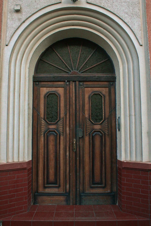 a building with an intricate wooden door on it