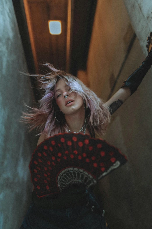 a woman with pink hair holding an umbrella