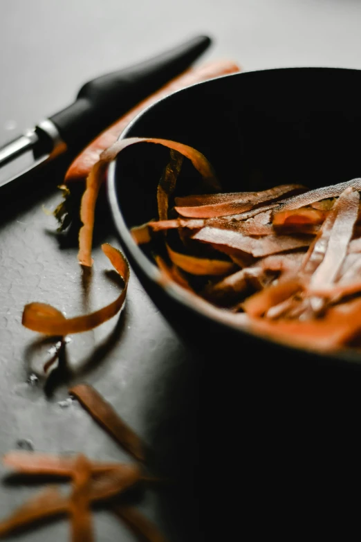 orange strips have been sliced up in a bowl