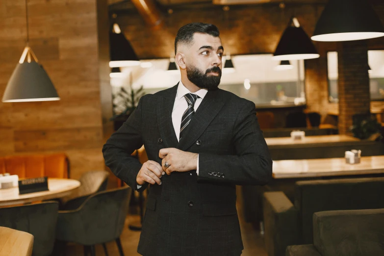 a man is standing in an elegant restaurant with chairs