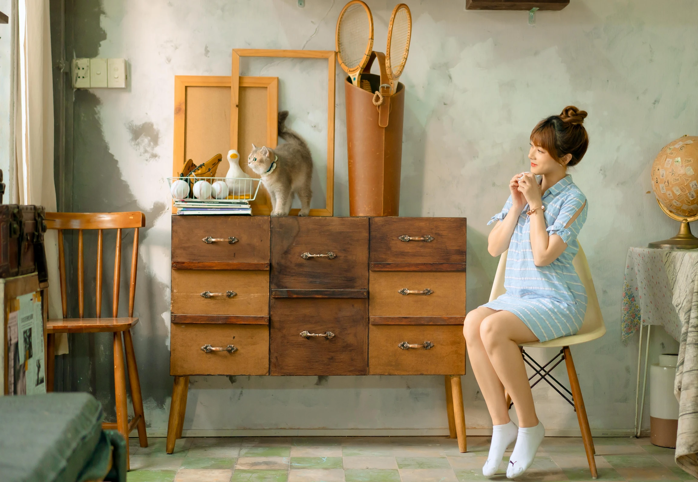 the woman is sitting on a chair with her hands in her mouth