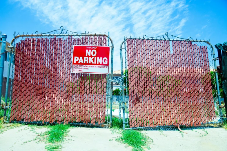 a gate with a no parking sign on the side