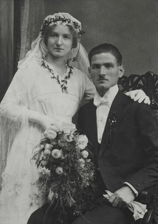 a couple are posing for a pograph on their wedding day