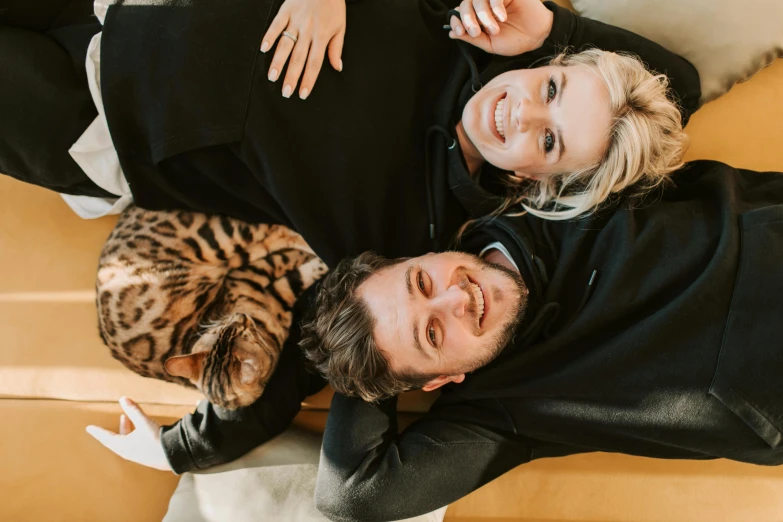 an overhead view of a man and woman, with one holding the woman's hand