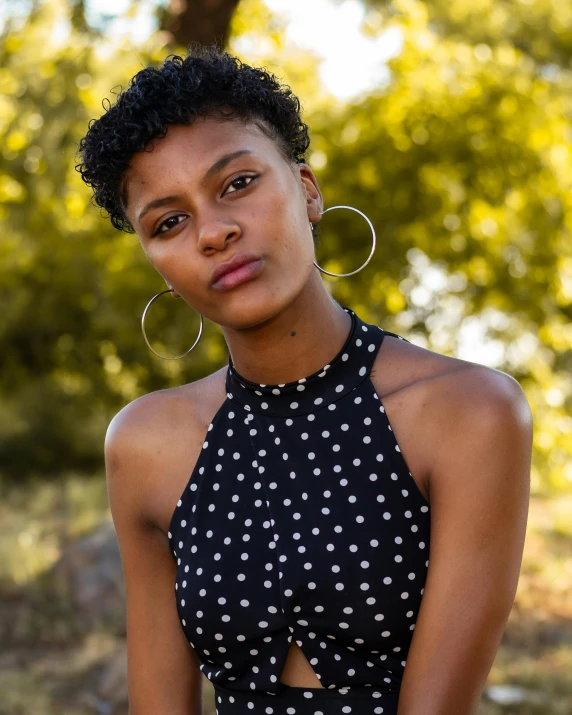 a woman poses for the camera while wearing large earrings