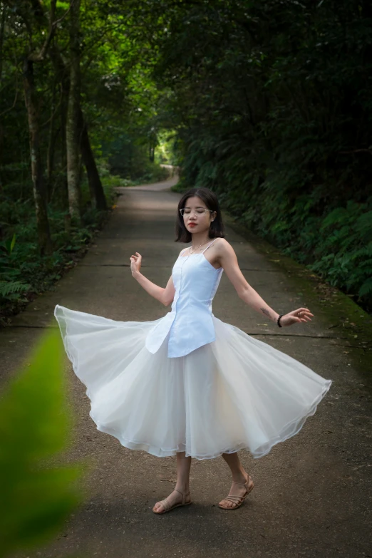 a woman in white dress posing for a po