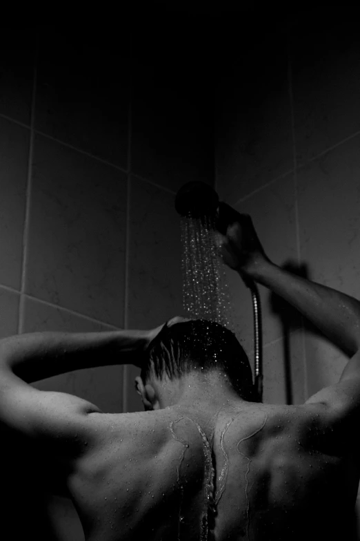 shirtless young man in shower taking a shower