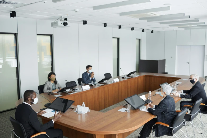 a meeting room set up with people at long tables