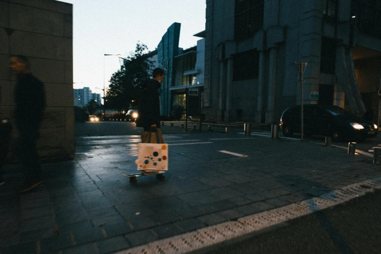 a white bag is standing in the middle of a sidewalk