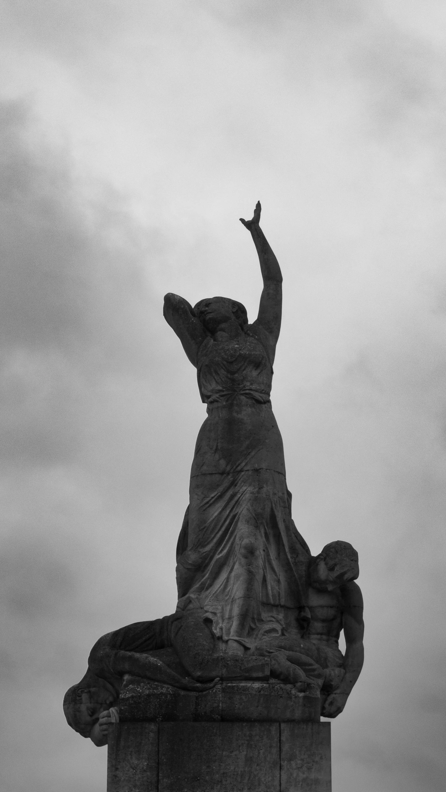 the statue is standing on the roof and there is a large bird in the air