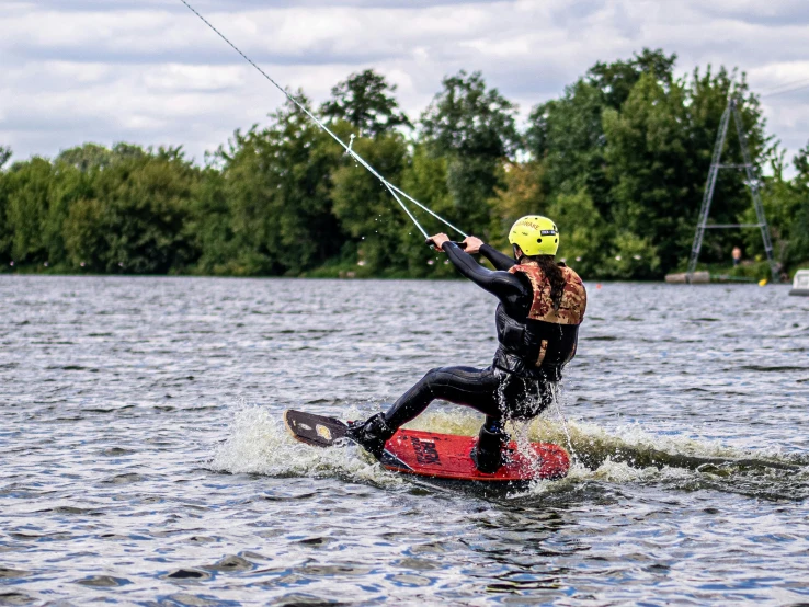 a man kite surfing on top of the water