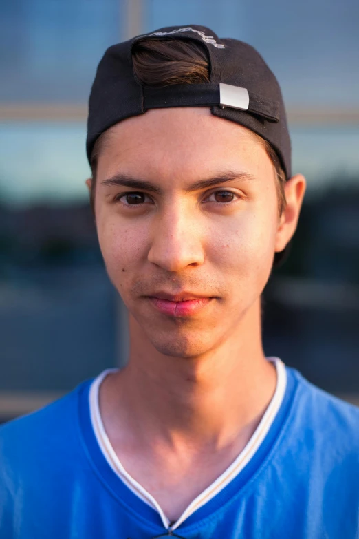 a boy with a baseball cap on is posing for a po