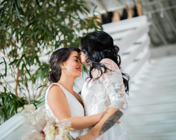 two women standing next to each other hugging