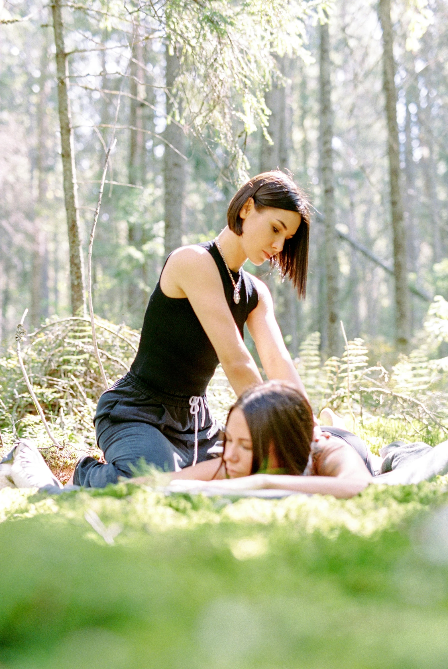 a couple of women in the woods playing with each other