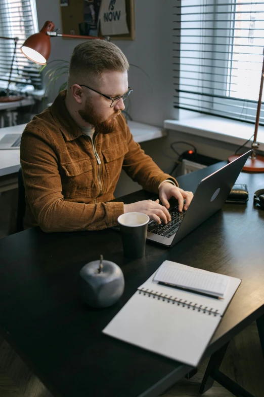 a man working on his laptop at the desk