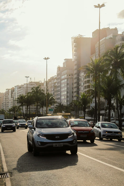 an intersection in an area with trees and cars driving