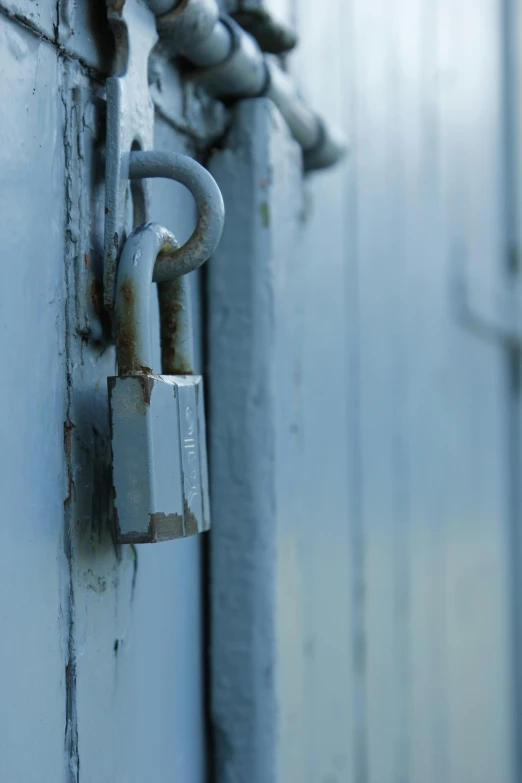 a combination lock is attached to a steel gate