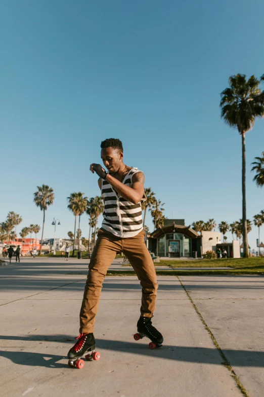 a man skateboarding with palm trees in the background