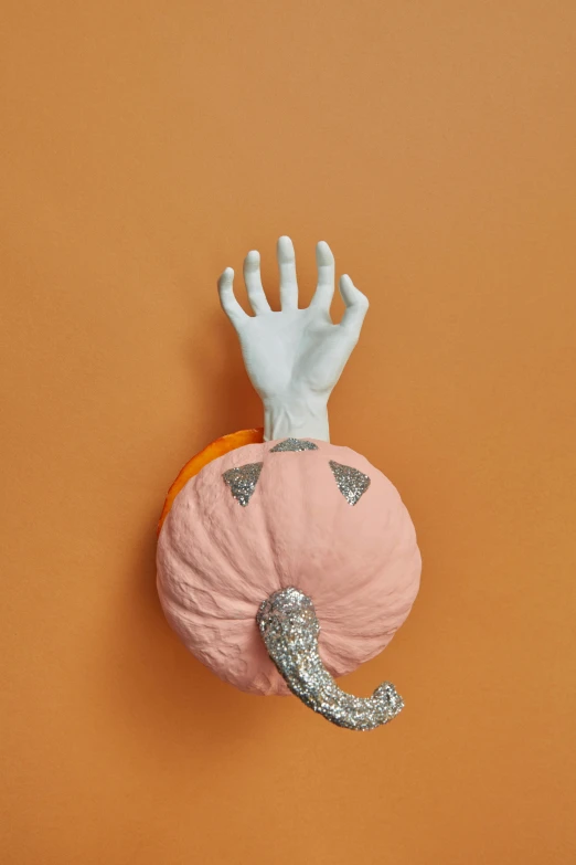 pink halloween pillow with hand outstretched above it