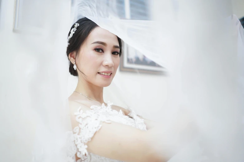 a beautiful young woman standing next to a window