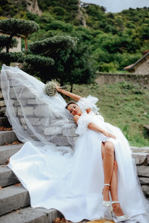 a woman is dressed up like a bride on the stairs