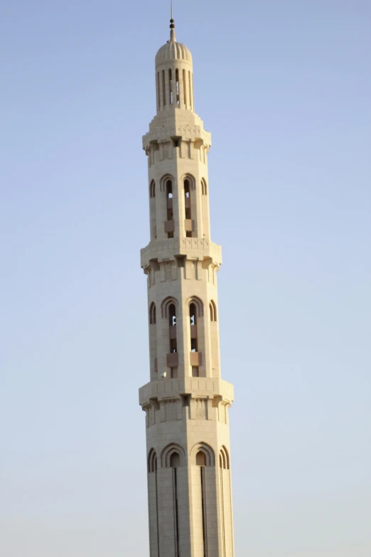 the clock tower at the end of a stone building