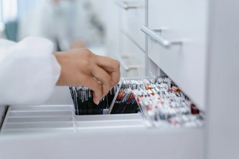 a woman placing toothbrushes inside a drawer