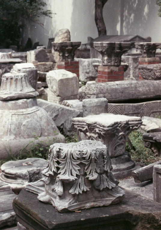 a stone bench next to some small stone sculptures