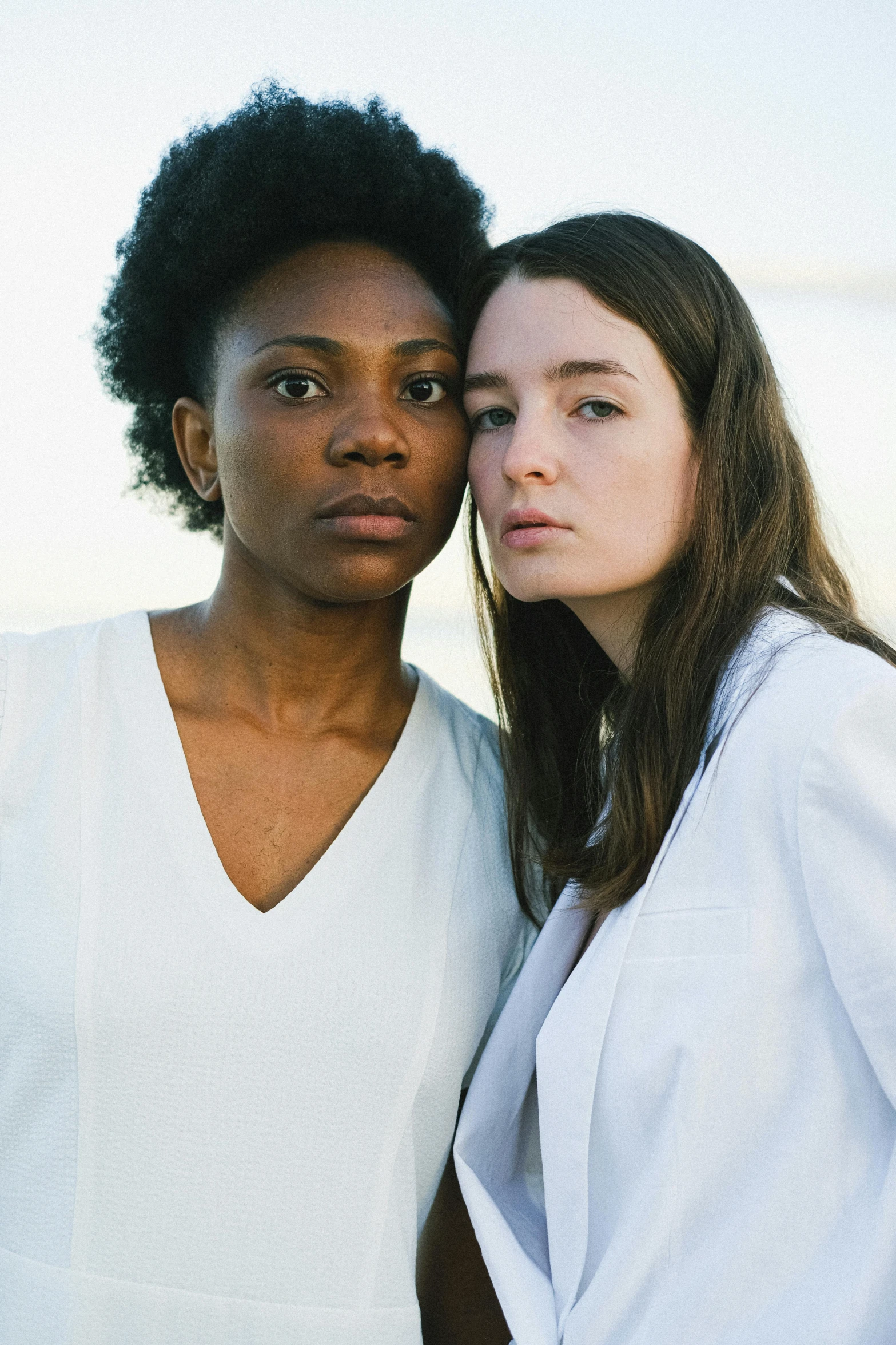 two women wearing white standing next to each other