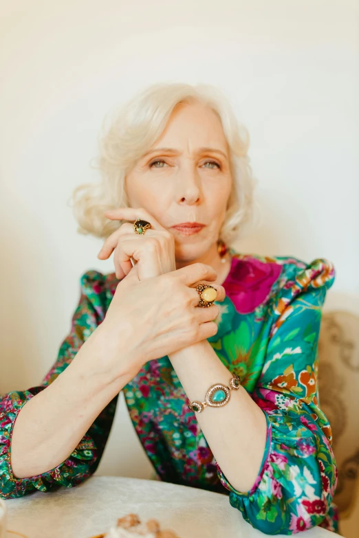 an older lady wearing jewelry posing for the camera