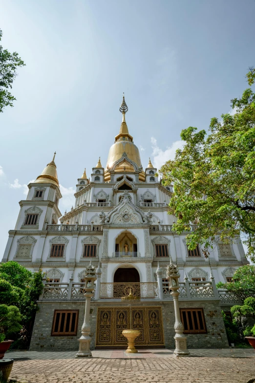 a view of a white building with a golden dome on top