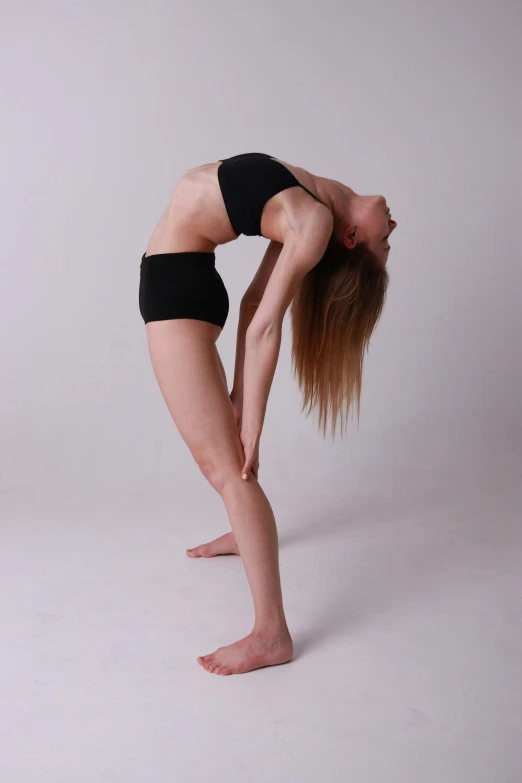 a woman does yoga pose with a white background