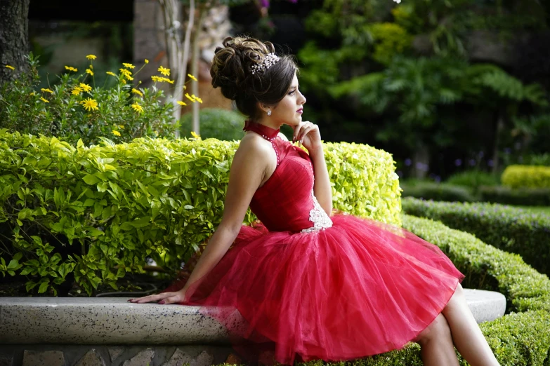 a beautiful woman in a red dress is posing on a bench