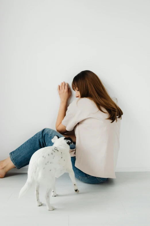 a little girl playing with a toy white dog