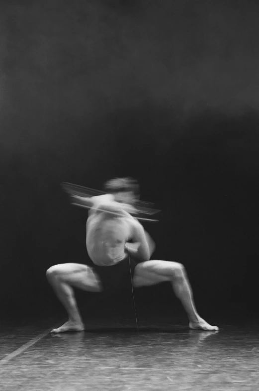 a person doing yoga poses on stage in the dark