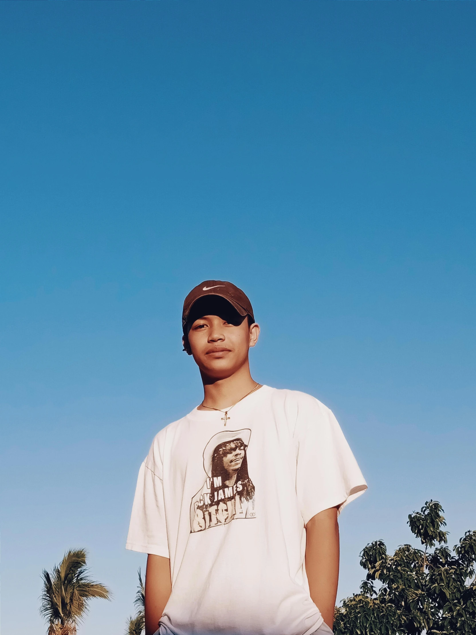 a young man is standing with his skateboard in hand