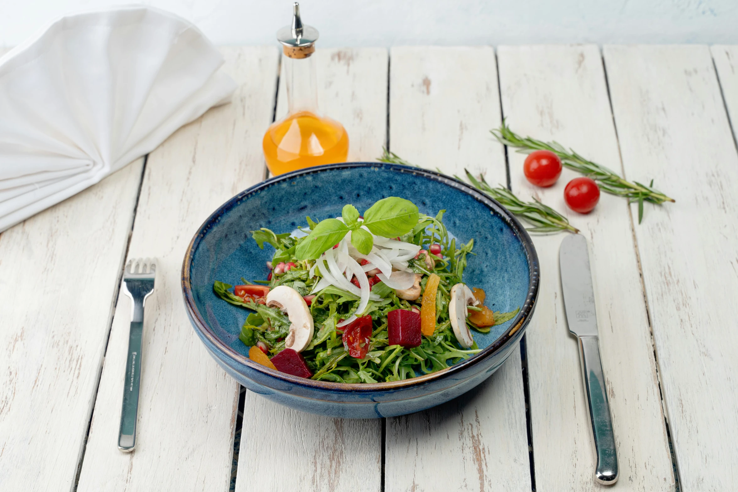 a plate with salad with some silverware on it