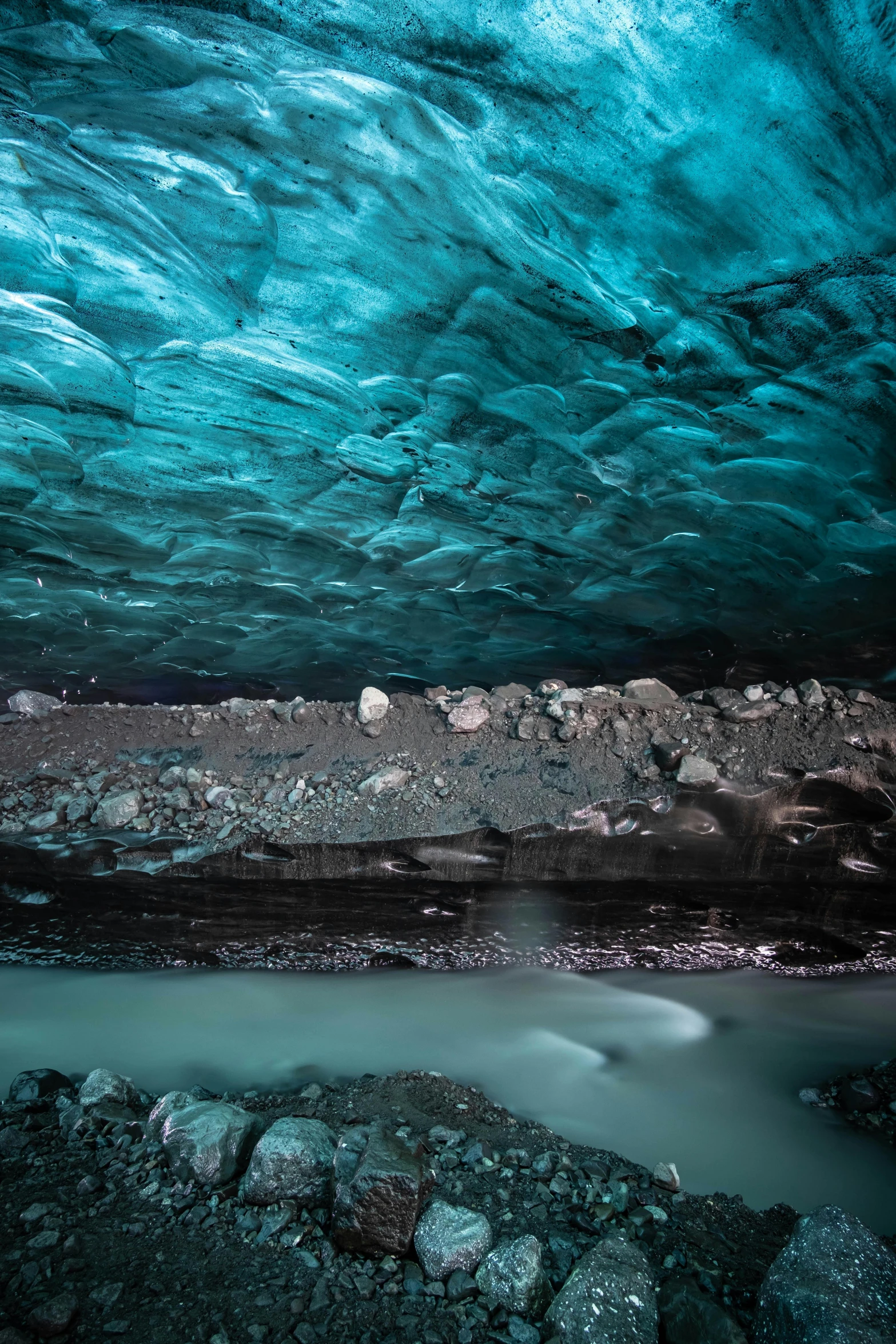 the inside of a cave under a very colorful sky