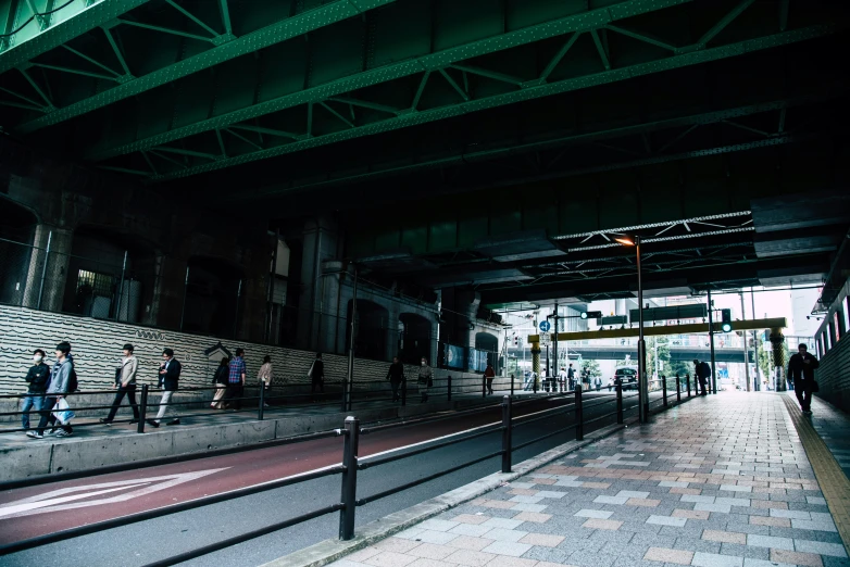 people walk through a dark subway area