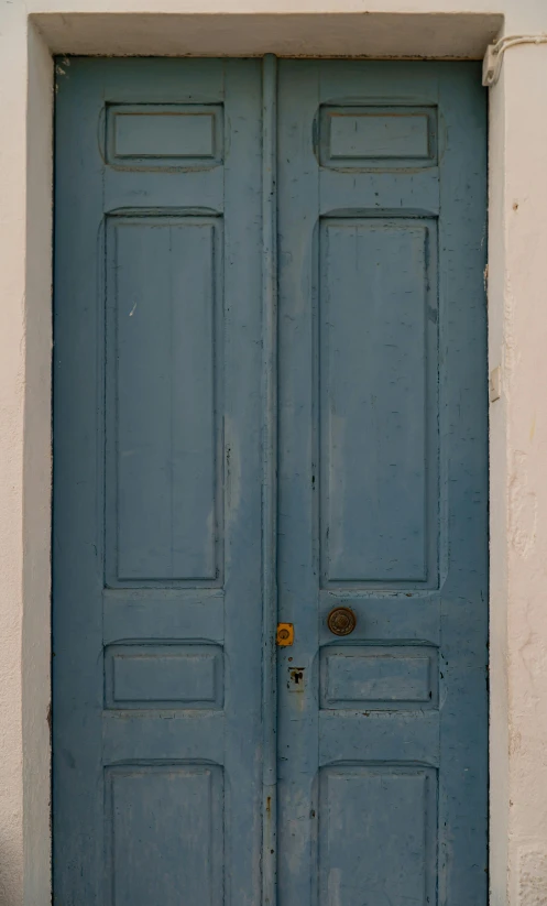 a blue front door with a brick step