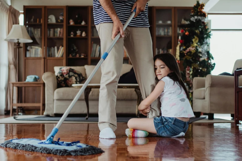 a mother and daughter cleaning the hardwood together