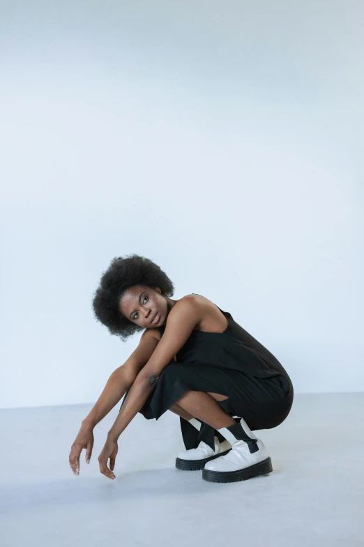 an image of a woman in short black dress posing