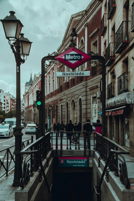 a street sign and some buildings with cars parked on the side