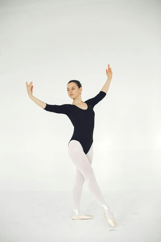 a young woman in ballet clothing posing for a po