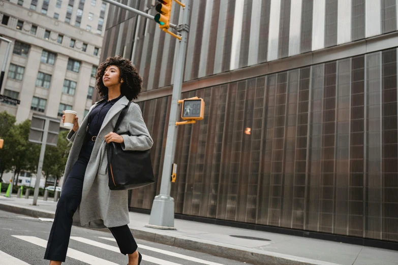 a woman holding onto her hand while walking across the street