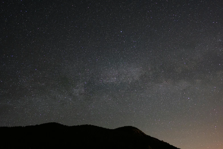 a very tall mountain with some stars in the sky