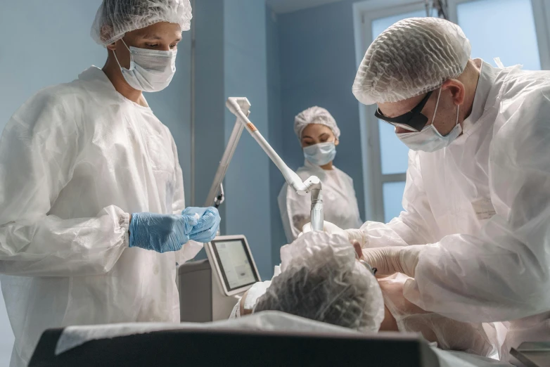 two people and a baby in a hospital room